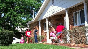 Women outside waiting.